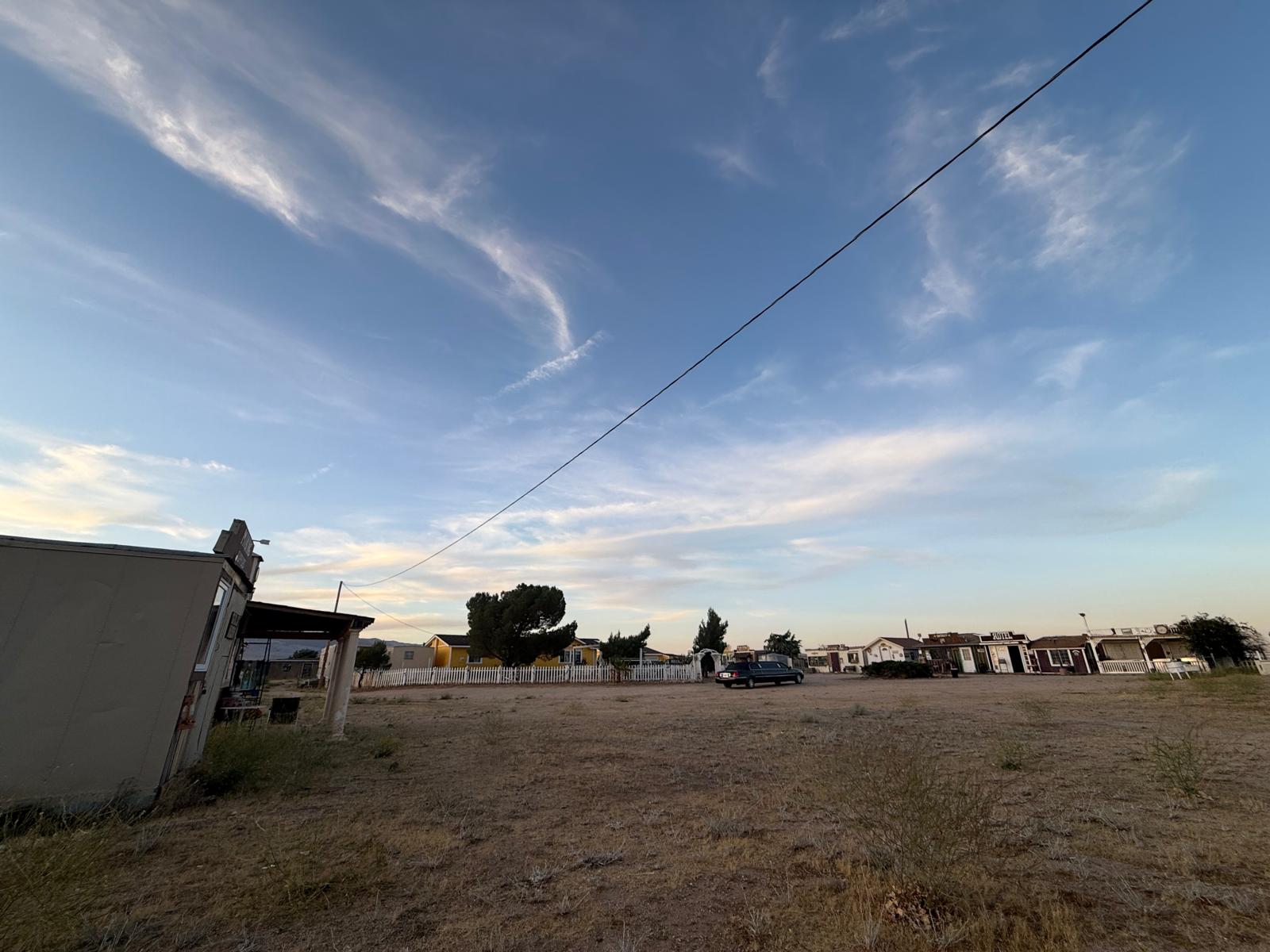 The Hikertown grounds at dusk, a single car parked far off